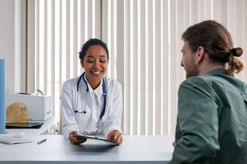 Doctor reviewing results with a patient during a consultation, the right first step when leg swelling is new or one-sided